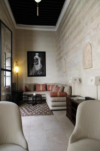 a living room with a couch and a table at Riad Dar Zen in Rabat