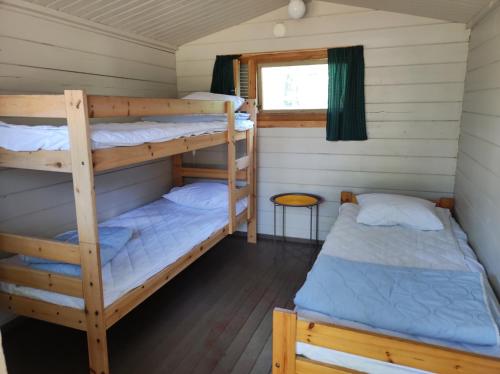 a room with two bunk beds and a window at Heinolan Heinäsaari - Holiday and Camping in Heinola