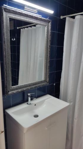 a bathroom with a white sink and a mirror at CASA MAR - NA NURI Menorca in Son Parc