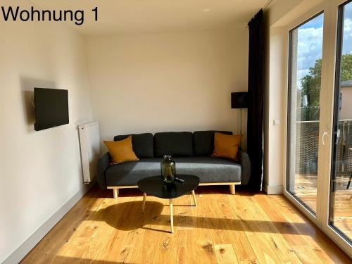 a living room with a couch and a table at Ferienwohnungen Tenner in Jüterbog
