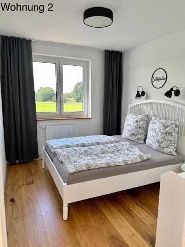 a bedroom with a bed and a window at Ferienwohnungen Tenner in Jüterbog
