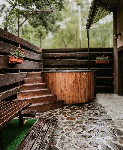 a set of wooden stairs with a wooden bench at Садиба Казка in Vizhenka