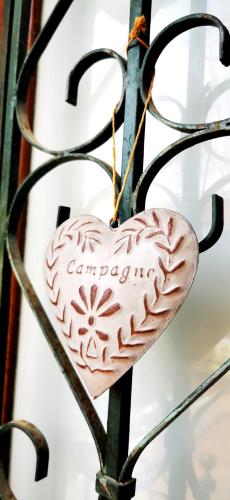 a wooden heart hanging on a metal gate at Vue magnifique, piscine privée chauffée et sauna à 10min de Monaco in Roquebrune-Cap-Martin