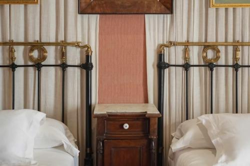 a bedroom with two beds and a wooden night stand at Landa in Burgos