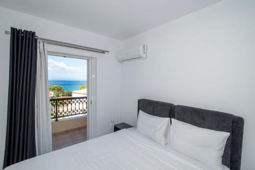 a bedroom with a bed with a view of the ocean at Mary's luxury apartment Elaia. in Elia Laconias
