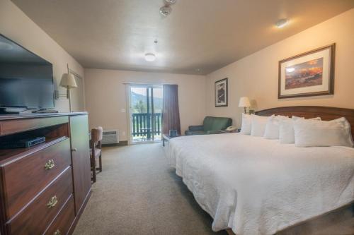 a hotel room with a bed and a television at Flying Saddle Resort and Steak House in Alpine