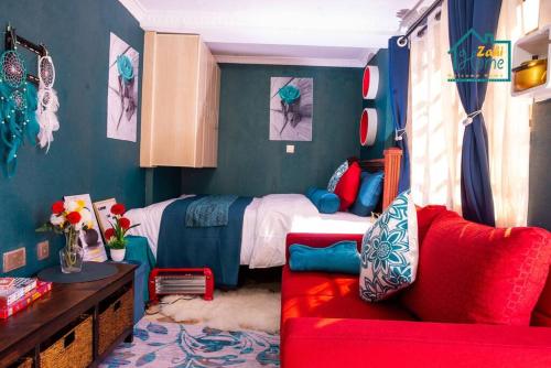 a bedroom with a bed and a red couch at Zahi Home, your cosy tiny home experience in Naro Moru