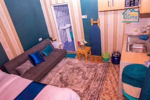 a living room with a couch and a sink at Zahi Home, your cosy tiny home experience in Naro Moru