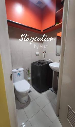a bathroom with a toilet and a sink at Shell Residences Studio Unit in Manila