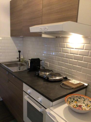 a kitchen with a sink and a counter top at Ostia Bed and Beach in Lido di Ostia