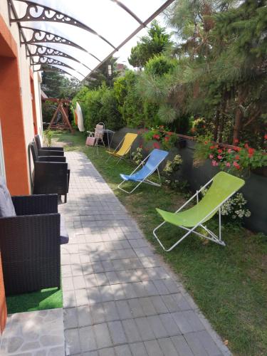 a patio with two lawn chairs and a table at Pokój X in Stegna