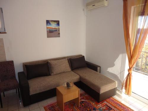a living room with a couch and a table at Apartments Villa Mićunović in Herceg-Novi