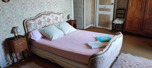 a bedroom with a bed with pink sheets and pillows at Les Terrasses d'Angoulême in Angoulême