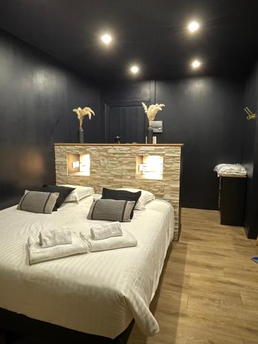 a bedroom with a large bed with white sheets at Spa & Love - Balnéo - Queen size - Cocooning in Aulnat