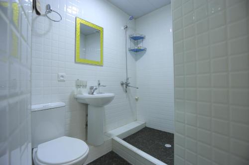 a bathroom with a toilet and a sink and a shower at Hotel Dilnura in Samarkand
