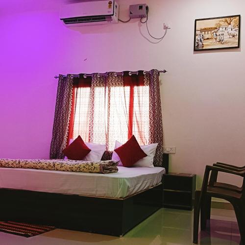 a bedroom with a bed with purple and pink lighting at The Mountain View Home Stay in Khajurāho