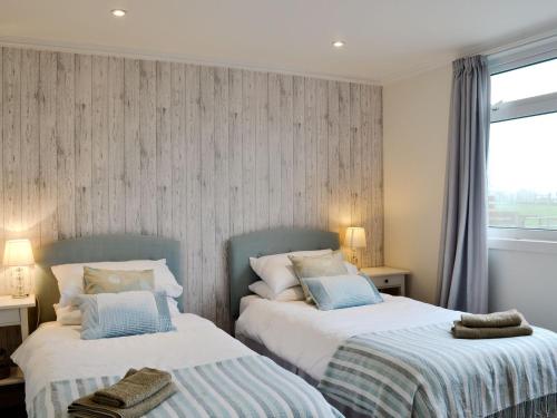 two beds sitting next to each other in a bedroom at Mid Bishopton Cottage - Uk10910 in Whithorn