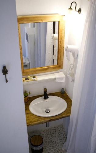 a bathroom with a sink and a mirror at Boutique Hostal La Curandera de Salinas in Ibiza Town