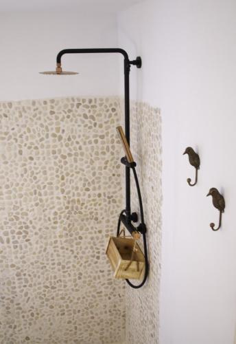 a shower with a wooden box in a bathroom at Boutique Hostal La Curandera de Salinas in Ibiza Town