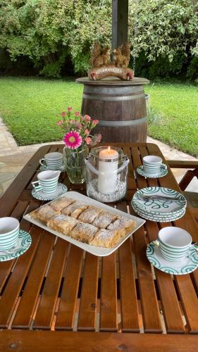 a table with a tray of pastries and plates on it at Die Landhausvilla in Unterach am Attersee in Unterach am Attersee