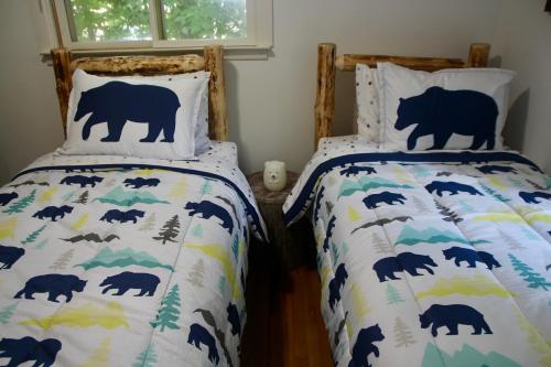 a bedroom with two beds with bears on them at Escape to a 3-Bedroom Cabin in Lower Catskills in Woodridge