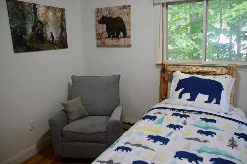 a bedroom with a bear bed and a chair at Escape to a 3-Bedroom Cabin in Lower Catskills in Woodridge