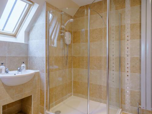 a bathroom with a shower and a sink at Little Arches - S4665 in Lochwinnoch