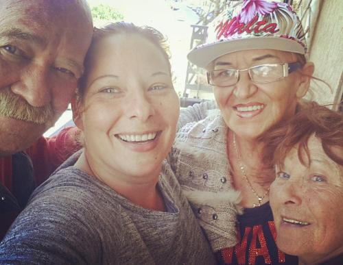a group of three people posing for a picture at Sunshine Court in St Paul's Bay
