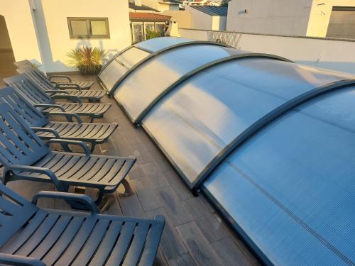 a row of chairs and a canopy on a patio at Casa do Martins in Esposende
