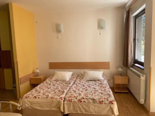 a bedroom with a bed with two pillows on it at Apart Hotel Flora Residence - Clover Building Flat 09 in Borovets