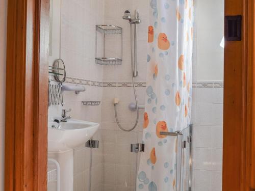 a bathroom with a sink and a shower at Angel Cottage in Oswaldkirk
