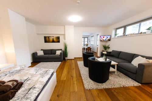 a living room with a couch and a table at 90 m2 horský apartmán v centru Harrachova in Harrachov