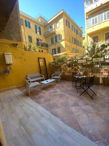 a patio with chairs and tables in a building at Cinemovie Guesthouse in Rome