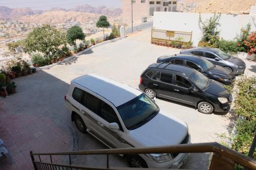 a group of cars parked in a parking lot at Petra Guests Hotel in Wadi Musa