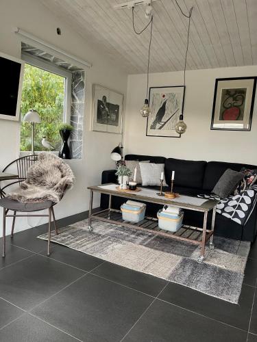 a living room with a couch and a table at Sillvik C&J Hugosson in Sanden