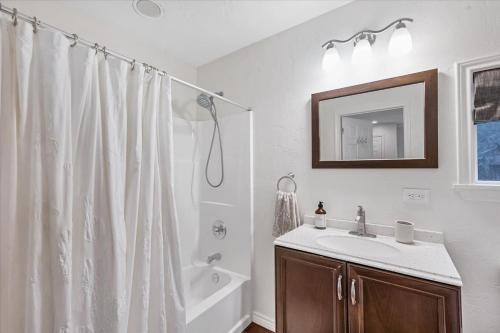 a bathroom with a shower curtain and a sink at Relaxing Alpaca Ranch Mins from Downtown Wimberley in Wimberley