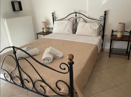 a bedroom with a bed with two towels on it at Nice Cosy apartment in Igoumenitsa in Igoumenitsa
