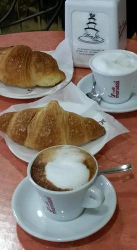 a table with two cups of coffee and two pastries at B&B Civico 64 Scalea in Scalea