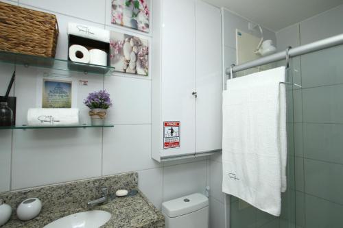 ein weißes Badezimmer mit Waschbecken und Toilette in der Unterkunft Flat Sun House Muro Alto - Conforto e Estrutura de Resort in Ipojuca