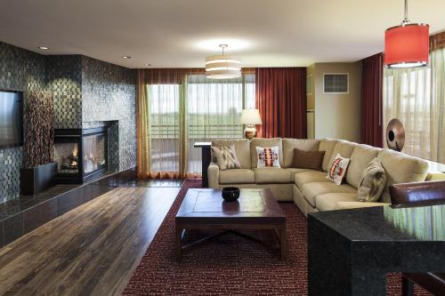 a living room with a couch and a fireplace at Shoshone-Bannock Hotel and Event Center in Fort Hall