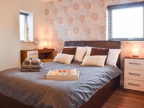 a bedroom with a bed with a tray of candles on it at The Plucking Barn in Llanwenog