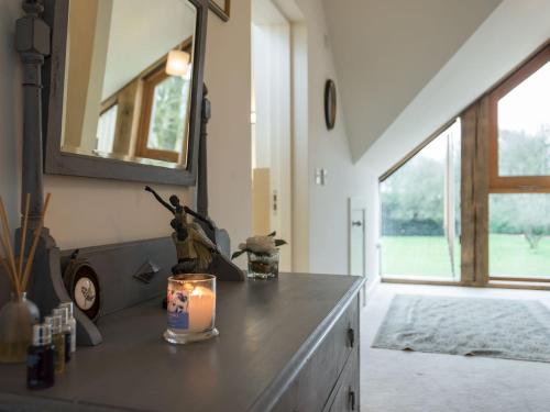 a room with a counter with a candle and a mirror at Lily Pad Lodge in Donington on Bain
