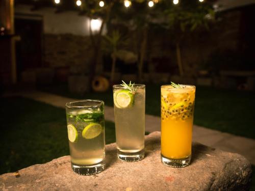 a group of three cocktails sitting on a table at Luisa in Ollantaytambo