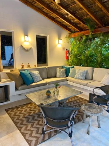 a living room with a couch and a table at Luxury Private Villas , Private Pool, Private garden, Jacuzzi, 24hours security in Tulum