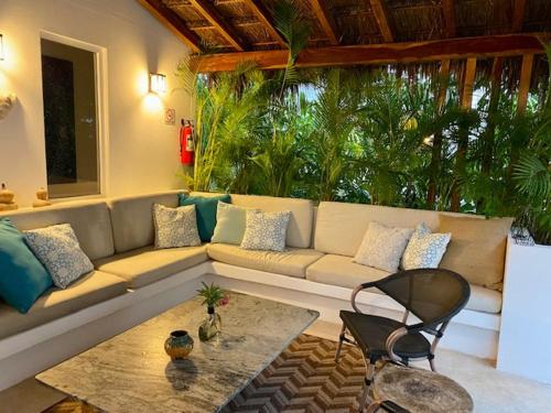 a living room with a couch and a table at Luxury Private Villas , Private Pool, Private garden, Jacuzzi, 24hours security in Tulum
