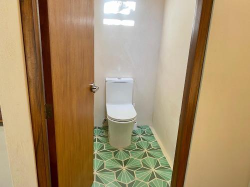 a bathroom with a toilet in a small room at Luxury Private Villas , Private Pool, Private garden, Jacuzzi, 24hours security in Tulum