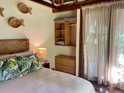 a bedroom with a bed and a large window at Luxury Private Villas , Private Pool, Private garden, Jacuzzi, 24hours security in Tulum