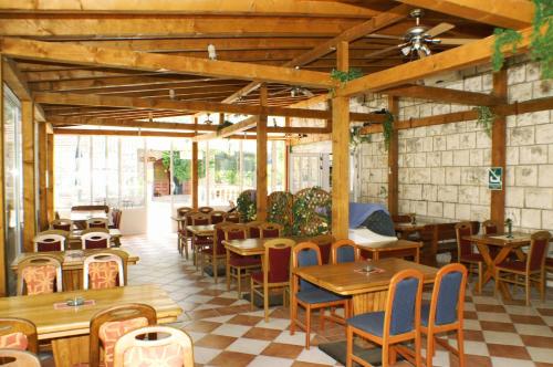 a restaurant with wooden tables and chairs in a room at Apartments by the sea Trpanj, Peljesac - 3162 in Trpanj