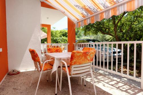 a porch with a table and chairs on a balcony at Apartments by the sea Trpanj, Peljesac - 3157 in Trpanj