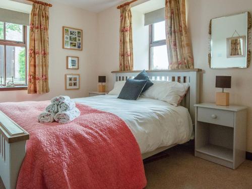 a bedroom with a bed with two teddy bears on it at Middle Lodge in Mintlaw